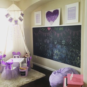 Girl's playroom chalkboard wall organization