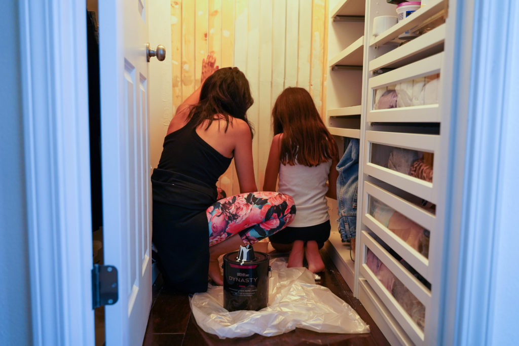 Mom and daughter painting closet paneled wall using Behr 2022 color of the year Breezeway which is like a seaglass green