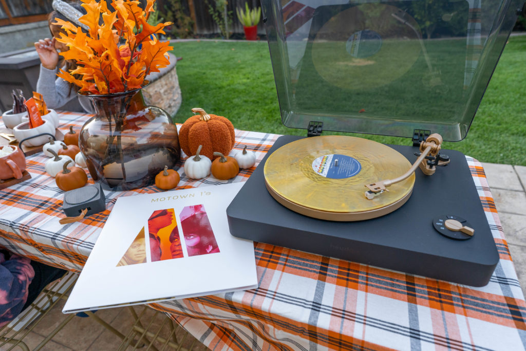 Fall table decor with pumpkins and leaves. Record player on table playing Motown hits