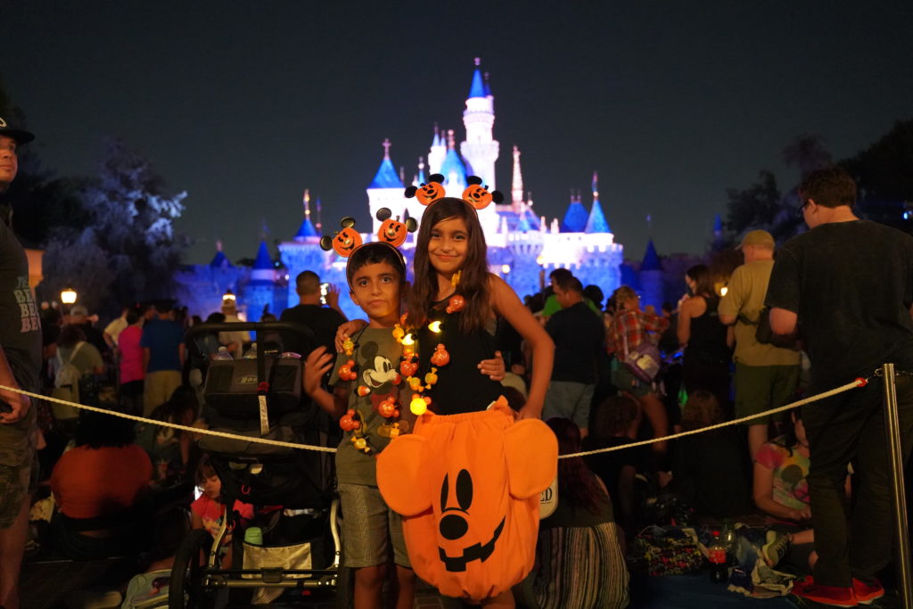 Young boy and girl waiting for fireworks so begin in front of Sleeping Beauty's castle in Disneyland