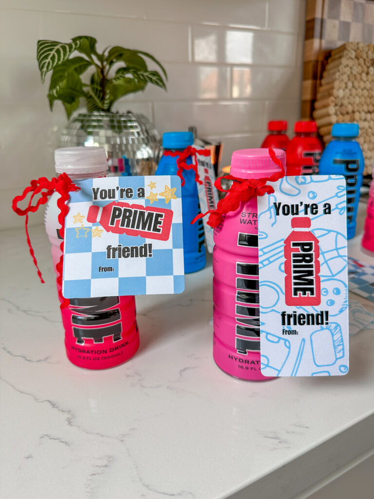 Prime Hydration drink bottles with printable valentine tags tied on with red ric rac ribbon. The valentines read: You're a 
PRIME friend