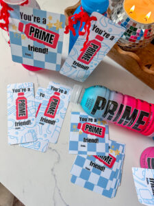 Prime valentine printable. Prime Hydration drink bottles with printable valentine tags tied on with red ric rac ribbon. The valentines read: You're a PRIME friend