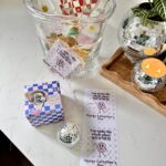 Galentine's hostess gift idea- Clear Ice bucket with disco ball bottle opener, topo chico, limes, tajin and valentine themed napkins