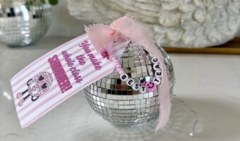 Swiftie Teacher appreciation gift idea- disco ball shaped trinket box with pink striped tag on it that says Teacher you make the whole class shimmer tied with a pink bow and friendship bracelet that says best teacher.