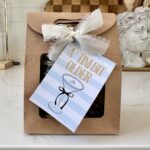 favor bag with gift tag that reads : A 'Tini bit older with bow and espresso martini art