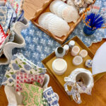 All the supplies needed for an oyster trinket dish- oyster and scallop shells, brushes, mod podge, decorative napkins, gold paint and scissors.