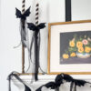 Dit bat bow garland halloween decorations on fireplace mantle and candlesticks