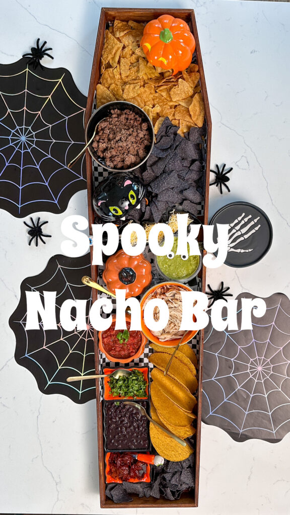 Halloween Nacho bar set up in wooden craft coffin on kitchen island with text that reads "spooky nacho bar"